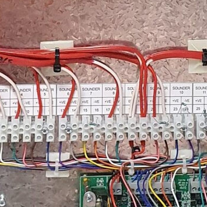 Labelled sounder terminals and neatly routed wiring in a Valley Fire alarm cabinet