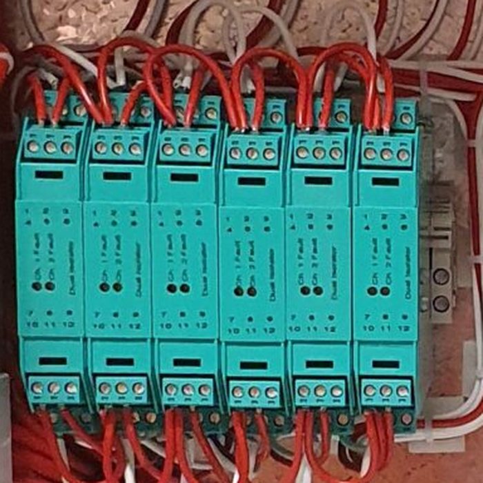 Row of isolator modules wired in a fire alarm cabinet